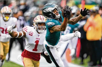  ?? SETH WENIG/ASSOCIATED PRESS ?? The 49ers were burned Sunday by a fourth-down catch by Eagles wide receiver Devonta Smith (right) that wasn’t even a catch. Smith’s 29-yard catch from Jalen Hurts to the San Francisco 6 was quickly followed by Miles Sanders’ TD run that opened the scoring.