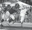  ?? J HARPER MEDIA ?? Wisconsin football recruit Dillan Johnson, out of Joliet Catholic near Chicago, tackles a ball carrier during the 2023 season.