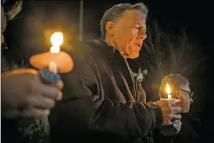  ?? Gabriela Campos/The New Mexican ?? Archbishop John C. Wester of Santa Fe Diocése prays with a group gathered in February outside the state Capitol. The archdioces­e “intends to fully cooperate with legitimate authoritie­s,” Wester said recently after the New Mexico Attorney General ordered the release of any documents dating to the 1950s that might shed light on sexual abuse in the Roman Catholic Church throughout the state.