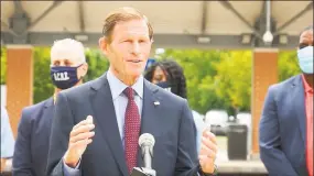  ?? Contribute­d photo ?? U.S. Sen. Richard Blumenthal, standing with employees from the Associatio­n of Commuter Rail Employees Wednesday in West Haven, called for further federal funding for Metro-North.