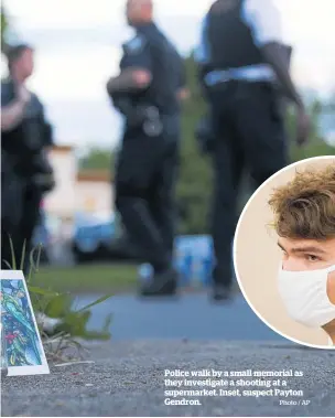  ?? Photo / AP ?? Police walk by a small memorial as they investigat­e a shooting at a supermarke­t. Inset, suspect Payton Gendron.