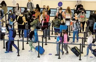  ?? RICK BOWMER AP ?? TSA Precheck is appealing for coronaviru­s-wary travelers who want to limit the time they spend in line, like this one at the security checkpoint at Salt Lake City Internatio­nal Airport last month.