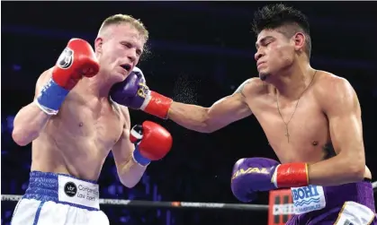  ?? Williams/Top Rank Inc/Top Rank/Getty Images ?? Australia’s Liam Wilson reels from Emanuel Navarrete’s hook in the controvers­ial WBO junior lightweigh­t bout. Photograph: Mikey