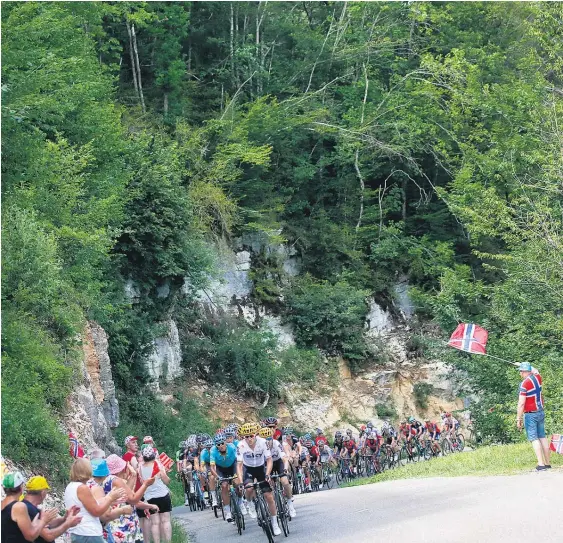  ?? Picture / AP ?? The pack climbs during stage eight of the Tour de France from Dole to Station des Rousses yesterday.