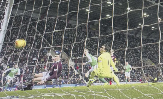  ??  ?? 0 Hibs striker Oli Shaw, centre, watches his seventh-minute effort bounce down off the bar and over the line but assistant referee Sean Carr did not give the goal.