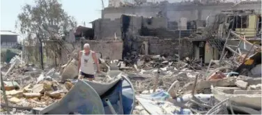  ?? Re ute ?? ±
A resident walks among ruins of residentia­l buildings destroyed by a Russian missile strike in Zatoka, Odesa region, on Tuesday.