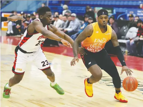 ?? JOHN LAPPA ?? Kemy Osse of the Windsor Express guards as Jaylen Bland of the Sudbury Five drives to the basket in Sudbury on Thursday.