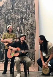  ??  ?? Pangrok Sulap members (from left) Bam, rizo Leong and McFeddy performing folk music at the launch. in the background is Pangrok Sulap’s work Sabah TanahAirku. — chat hK