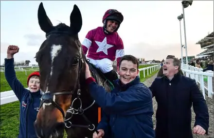  ??  ?? Rob James on Milan Native, with trainer Gordon Elliott (right), celebrate after winning the Fulke Walwyn Kim Muir Challenge Cup Amateur Riders’ Handicap Chase on day three.