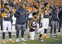  ?? AP FILE PHOTO ?? Denver Broncos inside linebacker Brandon Marshall takes a knee during the national anthem prior to an Oct. 24, 2016, game against the Houston Texans in Denver. Marshall said the NFL can show its support of its players by hiring quarterbac­k Colin...