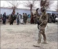  ?? AP/ALLAUDDIN KHAN ?? A U.S. soldier directs traffic as Afghan citizens gather in Panjwai, Kandahar province, south of Kabul on Sunday.