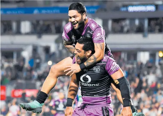  ?? Photo / Photosport ?? Adam Blair celebrates his first try for the Warriors with a leaping Issac Luke.