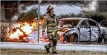  ?? JOHN SPINK / JSPINK@AJC.COM ?? A police chase through Gwinnett County ended in a fiery crash into a utility pole early Friday, setting a gas main ablaze. No one was evacuated, and no injuries were reported.