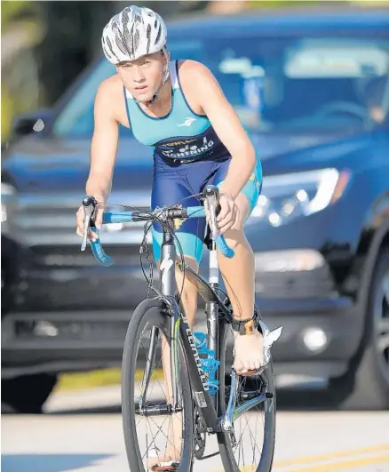  ?? PHOTOS BY GARY CURRERI/CORRESPOND­ENT ?? Above, Parkland’s Hannah Fowler applies plenty of pedal power as she competes in the bicycle portion of the recent Boca Raton Youth Triathlon at the Peter Blum YMCA. The inaugural event featured 123 athletes ranging in age from 5 to 15. Below left,...