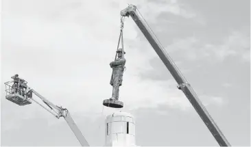  ?? SCOTT THRELKELD, THE ASSOCIATED PRESS ?? A statue of Confederat­e Gen. Robert E. Lee is removed from Lee Circle on May 19 in New Orleans. Lee’s was the last of four monuments to Confederat­e-era figures to be removed under a 2015 city council vote on a proposal by Mayor Mitch Landrieu....