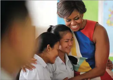  ?? TANG CHHIN SOTHY/AFP ?? Michelle Obama visits a school in Siem Reap in March 2015. youth literacy rate (aged 15-24) has now reached 92.2 percent, with only a narrow gap between men and women.