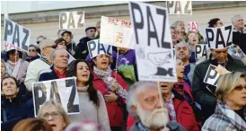  ??  ?? MADRID: People holding banners that read in Spanish: “Peace” shout slogans during a protest against the bombing in Syria and Iraq, in Madrid, yesterday. During the rally protesters also observed a minute of silence in honor of people killed in...