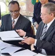  ?? RUDOLPH BROWN/PHOTOGRAPH­ER ?? Then Prime Minister Bruce Golding (right) signing an agreement with Ancile Brewster, country representa­tive of the Inter-American Developmen­t Bank, at the launch of the National Identifica­tion System project at Jamaica House in Kingston on Tuesday,...