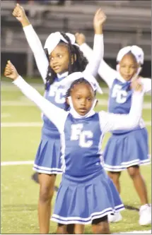  ?? Fred Conley • Times-Herald ?? A trio of Forrest City peewee cheerleade­rs perform a halftime routine for the crowd at Friday's home game against Nettleton.