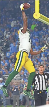  ?? MARK HOFFMAN / MILWAUKEE JOURNAL SENTINEL ?? Packers wide receiver Davante Adams decides to dunk his touchdown reception against Detroit on Jan. 1.