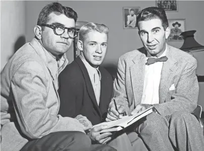  ?? THE COMMERCIAL APPEAL FILES ?? George Blancett of Humes High School was picked by the Quarterbac­k Club as player of the week the first week of November 1952. On the left is the backfield star's coach, Rube Boyce and on the right is Tom Swayze, an Ole Miss assistant coach and speaker at the Quarterbac­k Club luncheon.