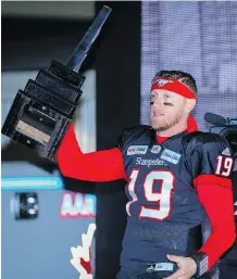  ?? AL CHAREST ?? Stampeders quarterbac­k Bo Levi Mitchell hoisted the West Division trophy Sunday, but he’s after the big one next Sunday.