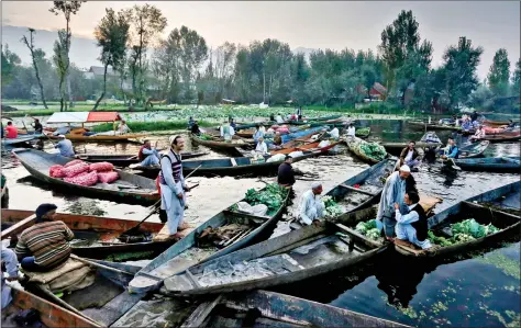  ??  ?? Vegetable vendors assemble at a floating market in the interiors of the Dal Lake in Srinagar on Thursday. REUTERS