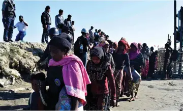  ??  ?? File photo shows Myanmar Navy personnel escorting Rohingya Muslims back to their camp in Sittwe, Rakhine state. — AFP photo