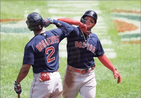  ?? Rob Carr / Getty Images ?? Red Sox outfielder Alex Verdugo, right, celebrates with Xander Bogaerts after hitting a home run against the Orioles earlier this season.