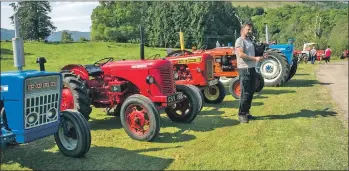  ??  ?? The 12th Killin tractor run rumbled across the Falls of Dochart on Saturday May 26, raising money for charity. The run began at Finlarig Farm and took the ‘caterpilla­r’ of tractors through the village of Killin, along the South Loch Tay road to...