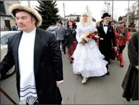  ?? AP/ ALIK KEPLICZ ?? Actors walk in a traditiona­l parade and show called “The Beheading of the Death,” performed Tuesday on the last day of the Carnival in Jedlinsk, Poland.