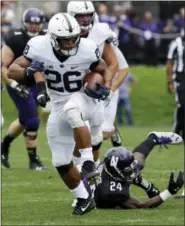  ?? NAM Y. HUH — THE ASSOCIATED PRESS FILE ?? File-This file photo shows Penn State running back Saquon Barkley (26) running for a touch down past Northweste­rn corner back Montre Hartage (24) during the second half of an NCAA college football game in Evanston, Ill.