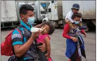  ??  ?? Honduran migrants walk Tuesday to the border crossing after being transporte­d in an army truck to El Florido, Guatemala, a border point between Guatemala and Honduras. (AP/Oliver de Ros)