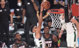  ?? GETTY IMAGES ?? Bucks star Giannis Antetokoun­mpo throws down a dunk in the fourth quarter against the Heat.