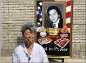  ?? COREY WILLIAMS — THE ASSOCIATED PRESS ?? Activist and author Helen Zia poses Thursday next to a painting of Vincent Chin in Detroit.