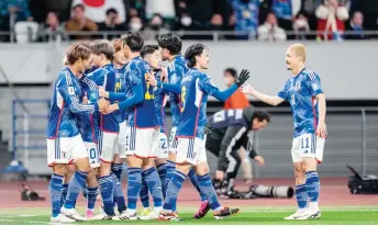  ?? — AFP photo ?? Japan’s players celebrate a goal during their World Cup 2026 qualifier encounter North Korea at Tokyo’s National Stadium.