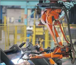  ?? — GETTY IMAGES FILES ?? A robot welder works on bridge components at factory in Gloucester, England.