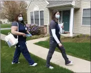  ??  ?? Johannie Rodriguez, a licensed practical nurse, and Jennifer Grandstrom, a registered nurse, arrive at Connie Ramsey’s house in Spring Township on Thursday to give her and her daughter, Jodie, doses of the Moderna COVID-19vaccine. Nurses from the Berks Community Health Center partnered with the Berks County Area Agency on Aging to provide in-home vaccinatio­ns for people who are homebound.