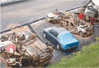  ??  ?? Some of the vehicles damaged by the floods and landslides last week.