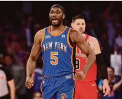  ?? Elsa/Getty Images ?? Precious Achiuwa of the New York Knicks celebrates his shot against the Chicago Bulls at Madison Square Garden on Sunday in New York. The Knicks won 120-119 in overtime.