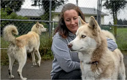  ?? PHOTO: ALDEN WILLIAMS/STUFF ?? Michelle Attwood with one of her rescue huskies, Robdog.