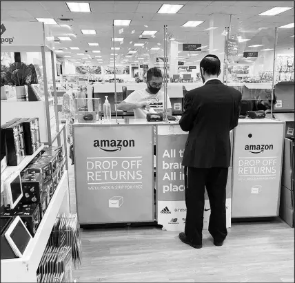  ?? NED SHAFFREY / AP FILE (2021) ?? People return items they bought online in person at an Amazon return counter inside a Kohl’s department store in 2021 in Clifton, N.J. Many retailers track returns, and if a shopper is dubbed a “serial returner,” they can be banned from bringing back products they say they no longer want or need.