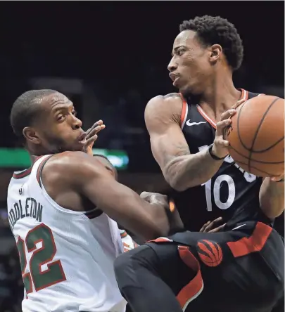  ?? ASSOCIATED PRESS ?? Toronto’s DeMar DeRozan drives past Milwaukee’s Khris Middleton during the first half on Friday.