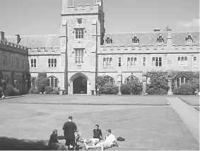  ??  ?? UCC students relaxing by the university building.