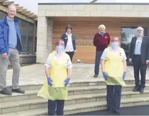  ??  ?? Award Left to right, president Andrew Hilley of Bridge of Allan and Dunblane Rotary Club, president Celia Norton of Alloa Rotary Club, James Muirhead, treasurer of the Carse of Stirling Rotary Club and Alan Bradshaw, president of Stirling Rotary Club. Dressed in the PPE are Aileen Stewart and Laura Johnston