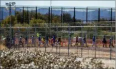  ?? IVAN PIERRE AGUIRRE VIA AP ?? In this Nov. 15 photo, migrant teens are led in a line inside the Tornillo detention camp holding more than