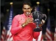  ?? JULIO CORTEZ — THE ASSOCIATED PRESS ?? Rafael Nadal, of Spain, holds up the championsh­ip trophy after beating Kevin Anderson, of South Africa, in the men’s singles final of the U.S. Open tennis tournament, Sunday in New York.