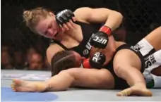  ?? JEFF GROSS/GETTY IMAGES FILE PHOTO ?? Ronda Rousey dominates Liz Carmouche during their UFC fight in 2013.