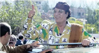  ?? JUDA NGWENYA ?? FORMER Libyan president Muammar Gaddafi gives a thumbs up at the AU summit in Maputo in this file picture. The writer asks who all was involved in helping Gaddafi loot the country’s coffers. | Reuters African News Agency (ANA)