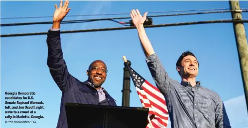  ?? BRYNN ANDERSON/AP FILE ?? Georgia Democratic candidates for U.S. Senate Raphael Warnock, left, and Jon Ossoff, right, wave to a crowd at a rally in Marietta, Georgia.